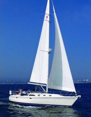 A cruising sailboat under full sail on open water